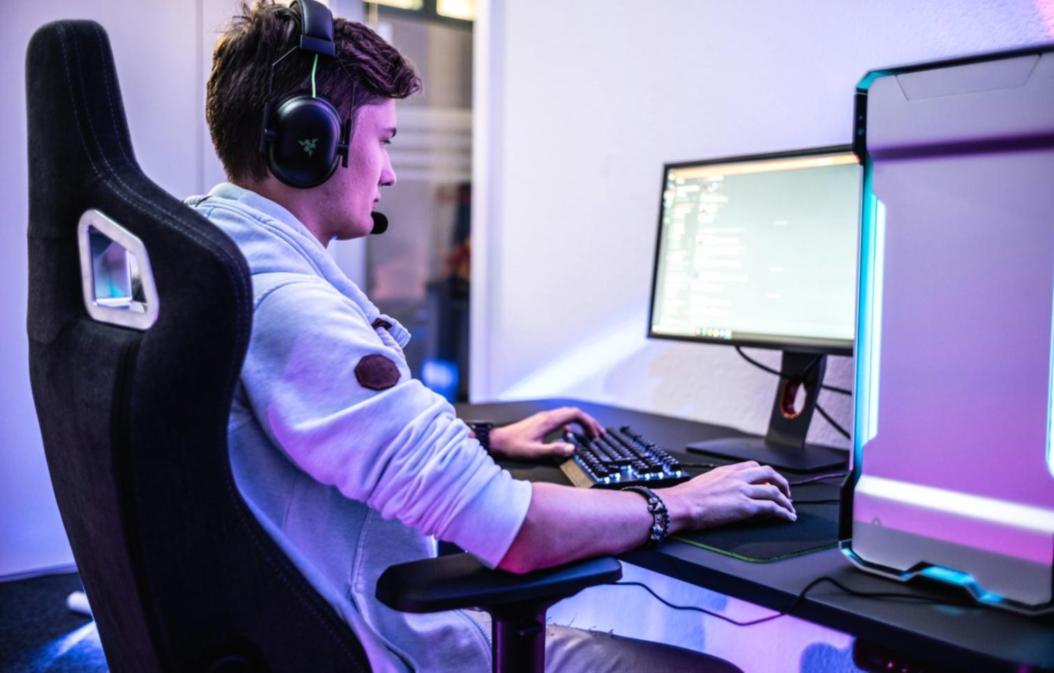 Modern esports arena showing competitive gaming setup with professional lighting and spectator areas