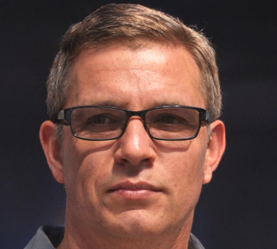 Experienced esports coach and data analyst working with team performance metrics and strategic planning materials